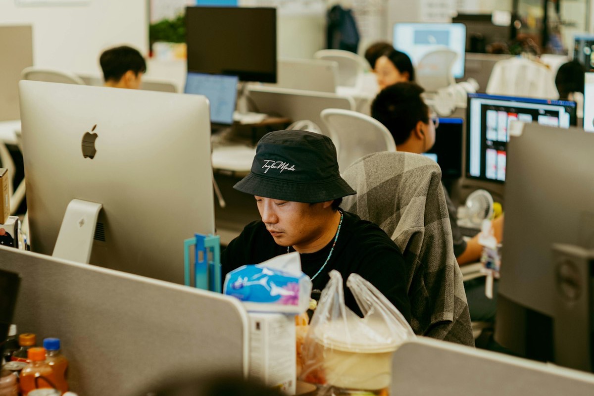 A support team handling customer conversations together through computers in a shared office