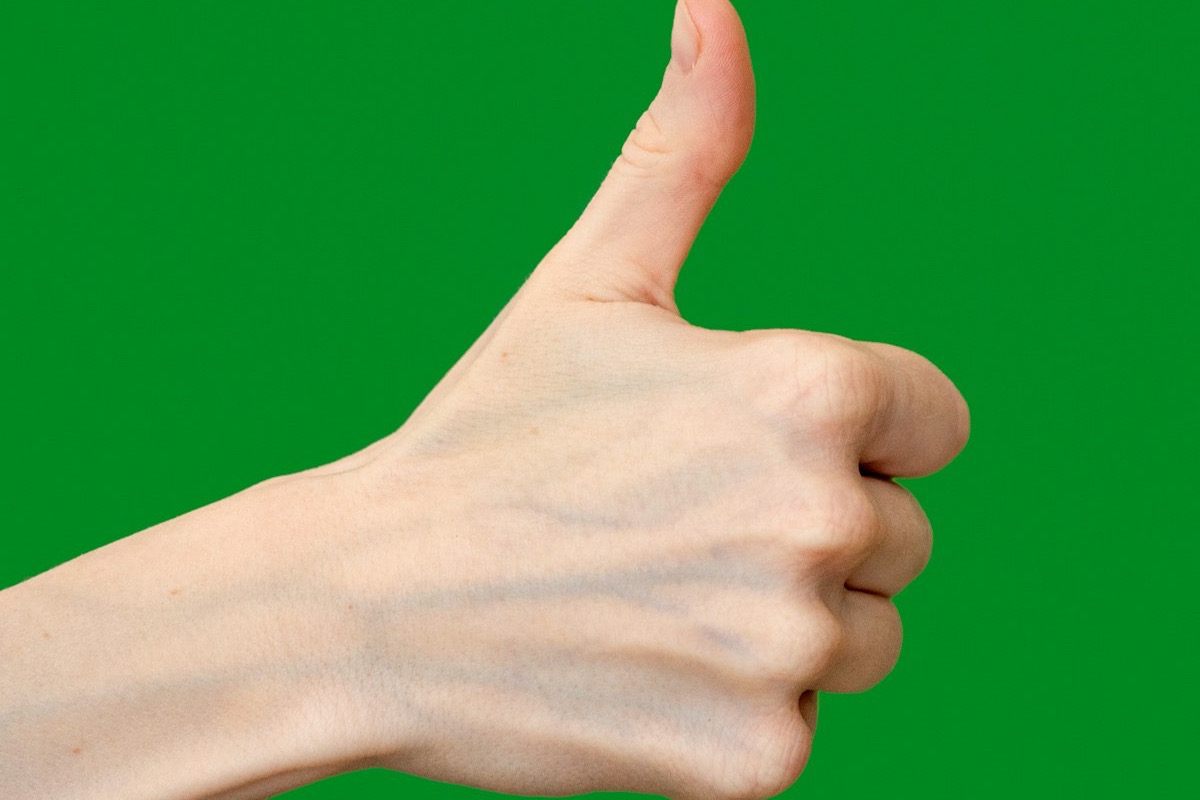 A green thumbs-up signalling a WhatsApp message template approved and ready to send