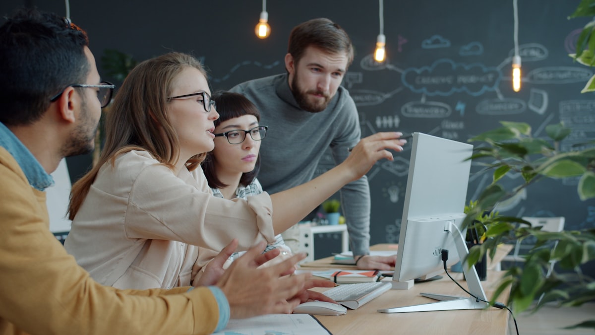 A team drafting WhatsApp message templates together at a screen for approval